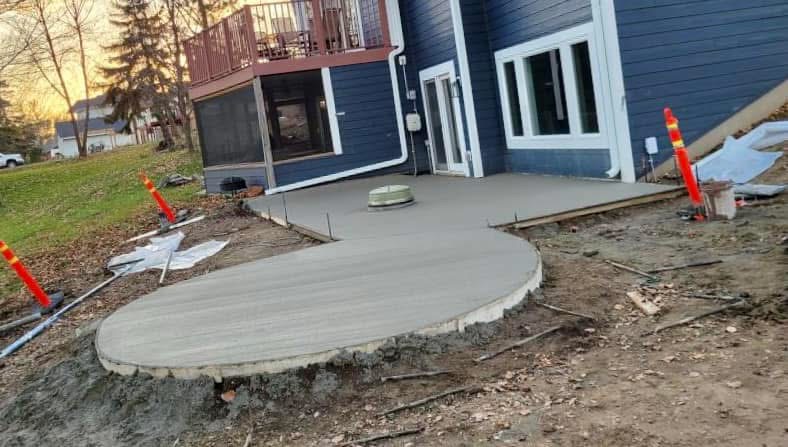 Round patio slab poured behind a lake home