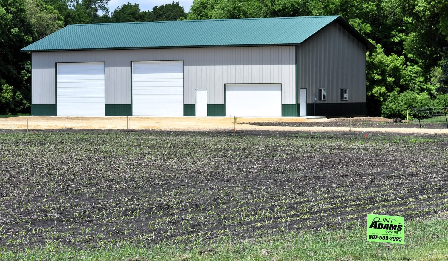 New concrete aprons outside a pole shed's garage doors