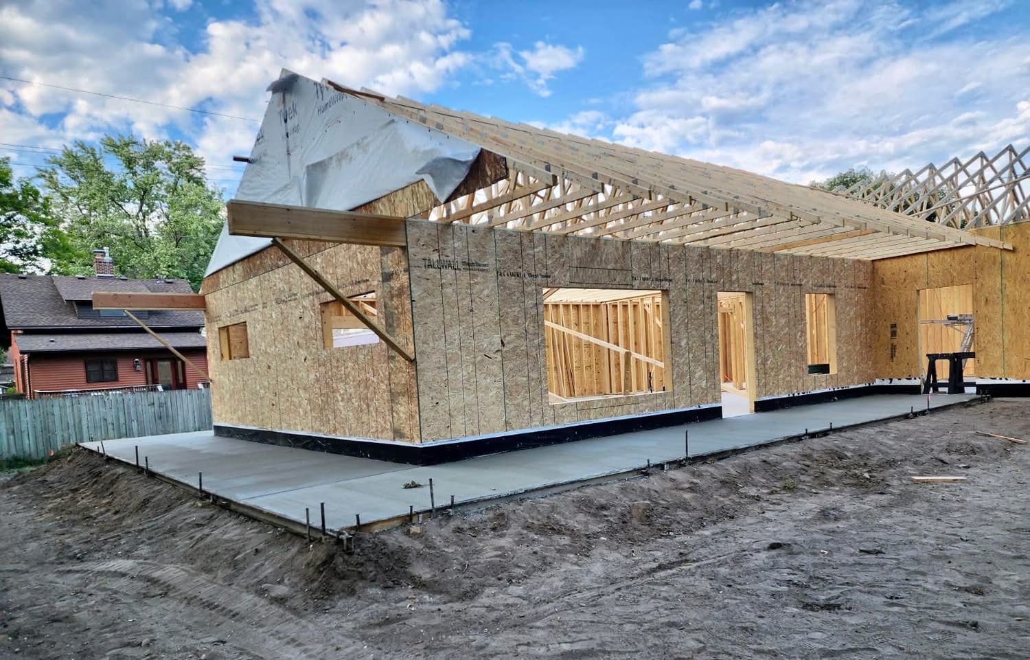 Poured slab and frost edge under a newly framed house